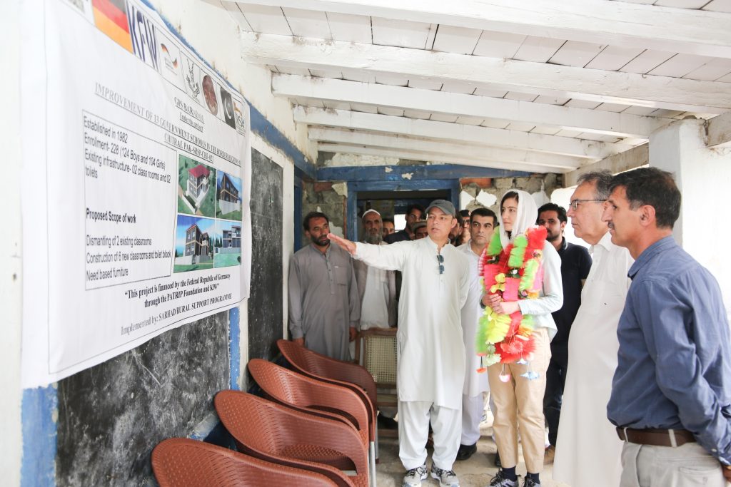 Mian (wearing the grey cap) explaining the project plan during the opening ceremony for the construction of a government primary school in Baradum, Chitral District.